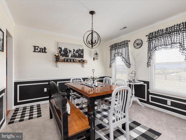 carpeted dining space featuring crown molding, plenty of natural light, and a notable chandelier