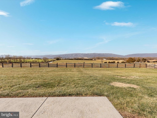 view of yard with a mountain view and a rural view