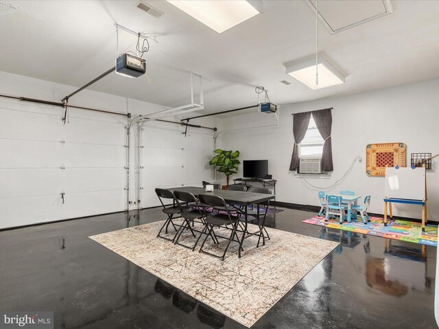 garage featuring cooling unit and a garage door opener