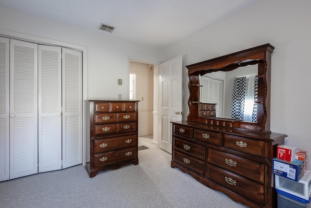 carpeted bedroom with a closet