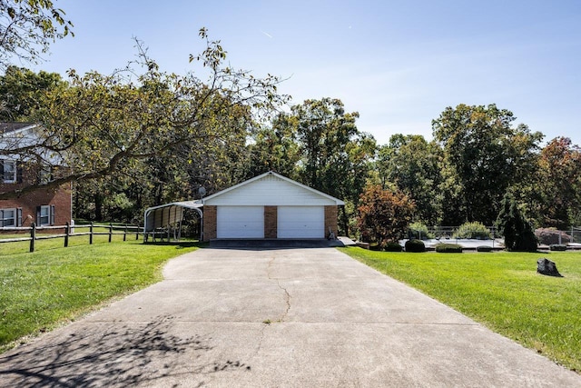 view of side of property with a carport, a garage, and a lawn