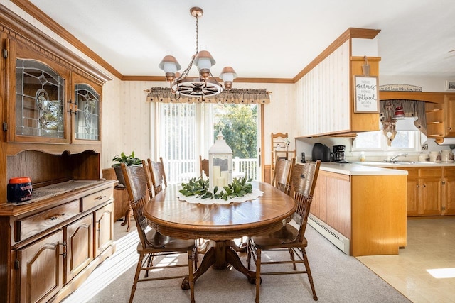 dining room with baseboard heating, ornamental molding, a chandelier, and sink