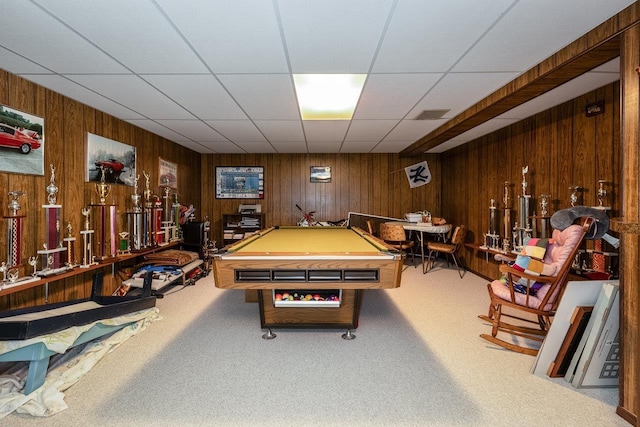 rec room featuring pool table, wooden walls, carpet, and a drop ceiling