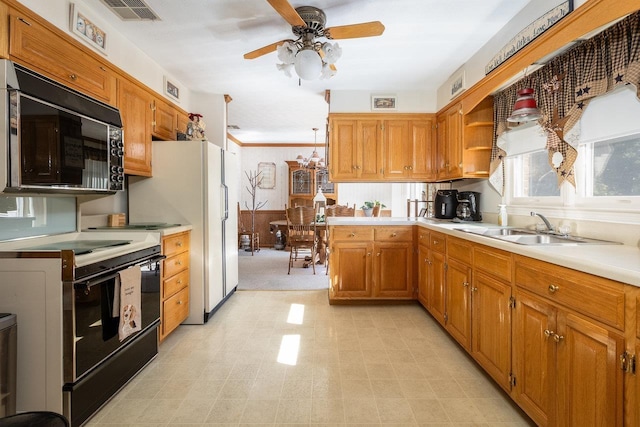 kitchen with black appliances, sink, ornamental molding, ceiling fan, and kitchen peninsula