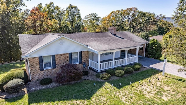 ranch-style home with a front lawn and a porch