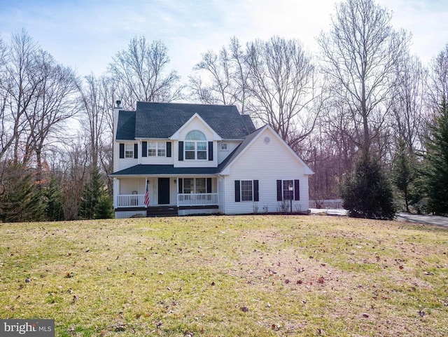 view of front facade with covered porch, a chimney, and a front yard