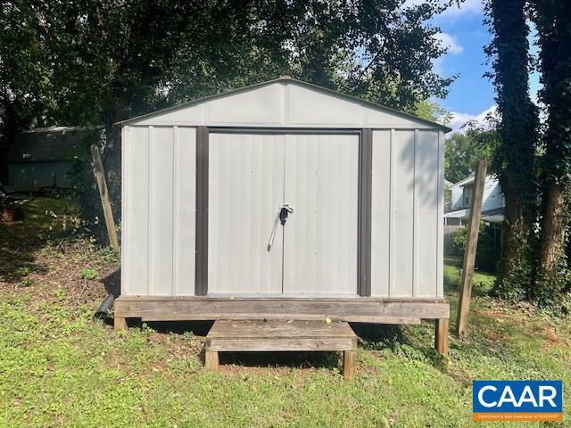 view of outbuilding featuring a lawn