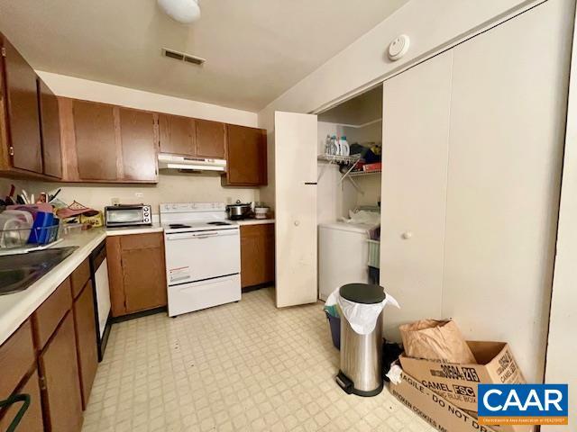 kitchen featuring white appliances and sink