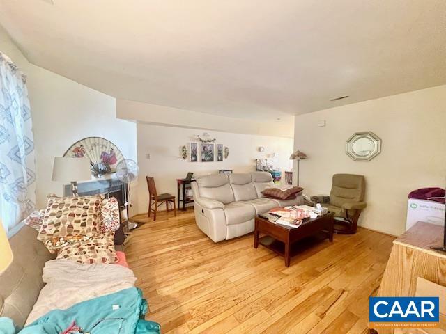 living room with light hardwood / wood-style flooring