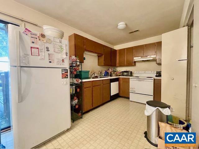 kitchen featuring sink and white appliances