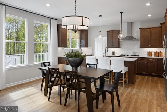 dining area featuring sink and light hardwood / wood-style floors