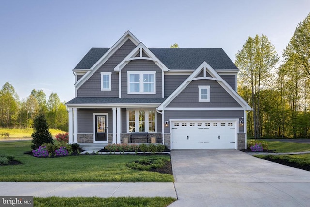 craftsman inspired home featuring a garage, a front lawn, and a porch