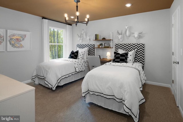 carpeted bedroom featuring a notable chandelier