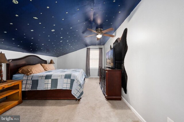 carpeted bedroom featuring vaulted ceiling and baseboards