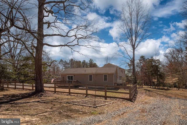 rear view of house with a fenced front yard