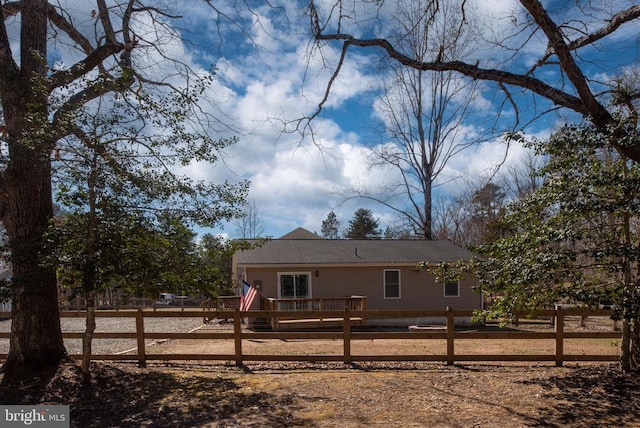 rear view of property featuring a fenced front yard