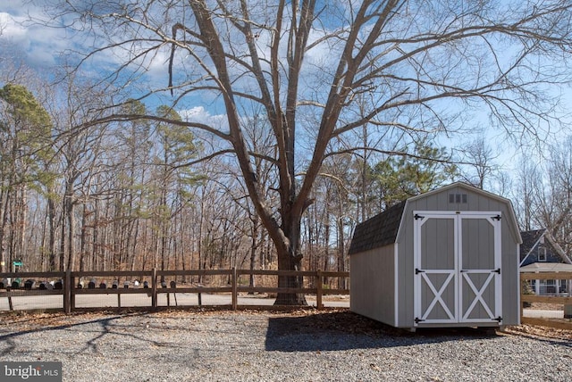 view of shed featuring fence