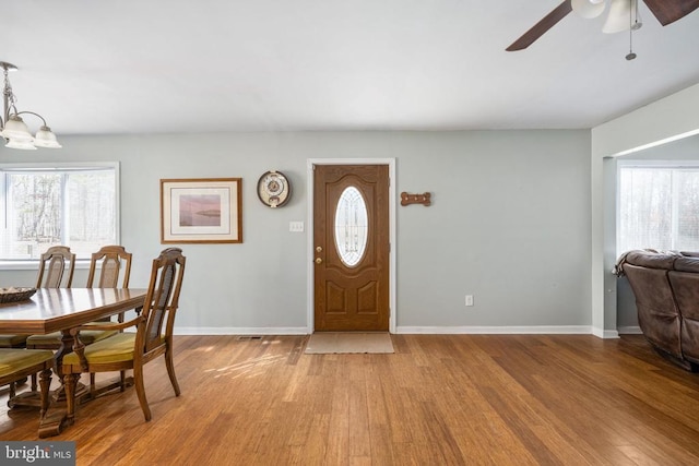 entryway featuring light wood-type flooring, plenty of natural light, and baseboards