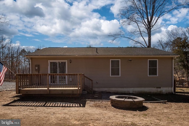 rear view of property with a deck, an outdoor fire pit, and crawl space