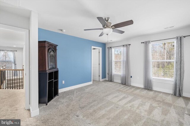 unfurnished bedroom with light carpet and ceiling fan