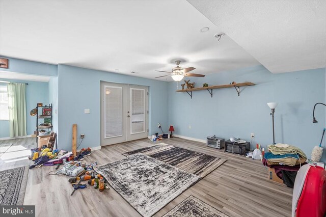 miscellaneous room featuring light hardwood / wood-style flooring, french doors, and ceiling fan