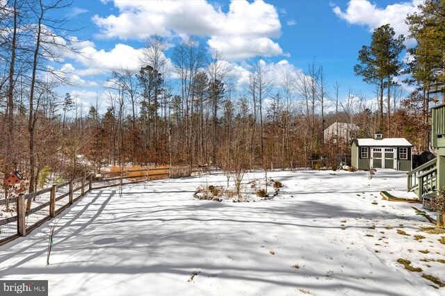 yard layered in snow with an outdoor structure