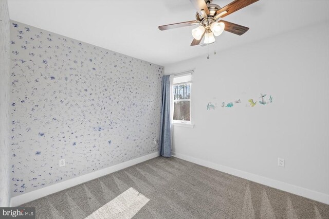 spare room with carpet floors and ceiling fan