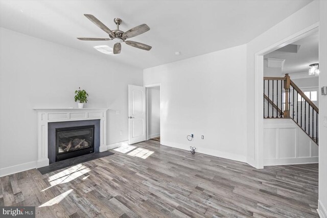 unfurnished living room with ceiling fan and light hardwood / wood-style floors