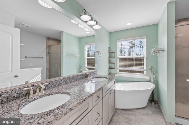 bathroom with vanity, plus walk in shower, and tile patterned flooring