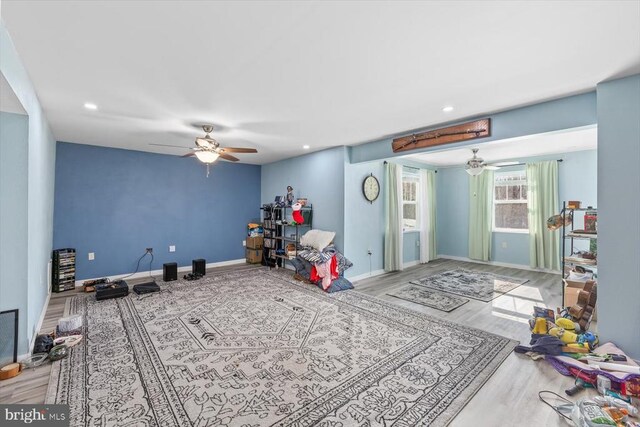 recreation room featuring wood-type flooring and ceiling fan