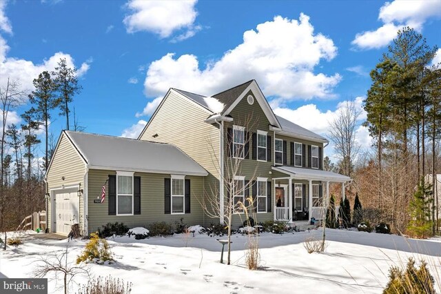 view of front of property with a garage and covered porch