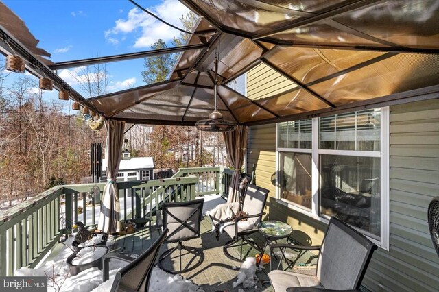 snow covered deck featuring ceiling fan