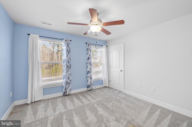 carpeted empty room with ceiling fan