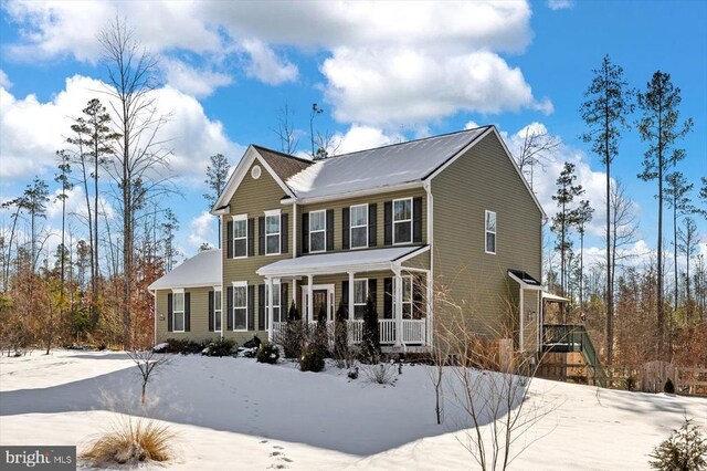 colonial home featuring covered porch