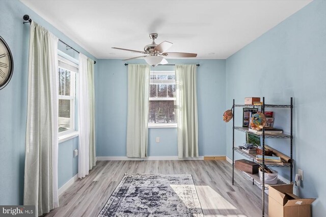 interior space with ceiling fan