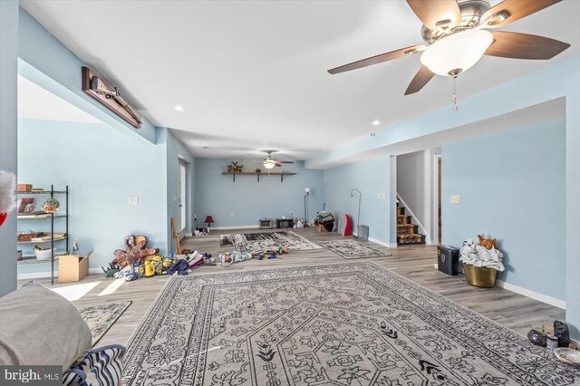 living room featuring hardwood / wood-style flooring and ceiling fan