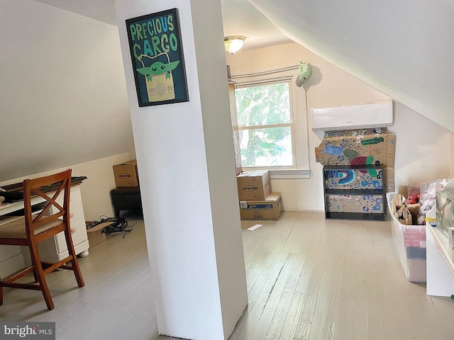 additional living space featuring lofted ceiling and wood finished floors