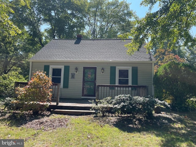 bungalow with a shingled roof and a porch