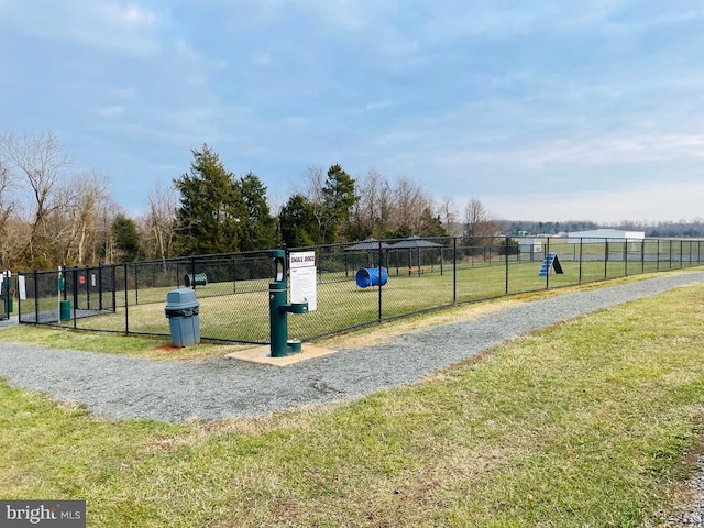 surrounding community featuring a yard and fence