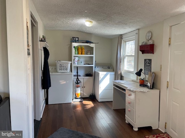 laundry room featuring dark wood-style floors, washing machine and dryer, laundry area, and a textured ceiling