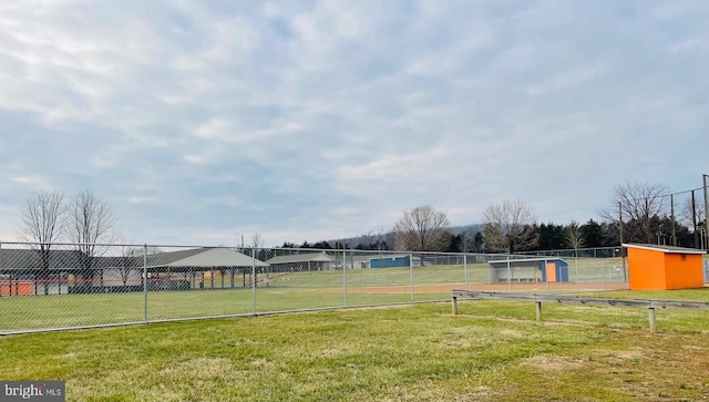 view of property's community with a yard and fence