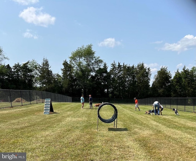 surrounding community featuring fence and a lawn