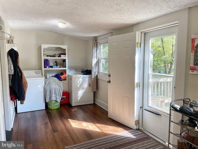 doorway to outside with a textured ceiling, independent washer and dryer, and wood finished floors