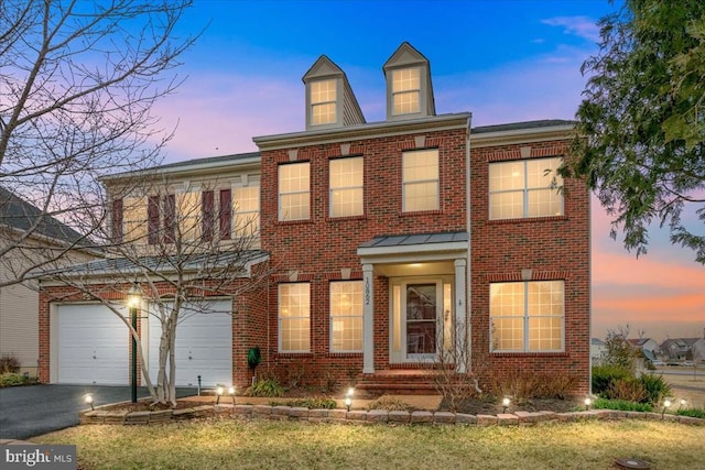 view of front of home featuring aphalt driveway and brick siding