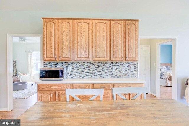 kitchen featuring decorative backsplash and light brown cabinets