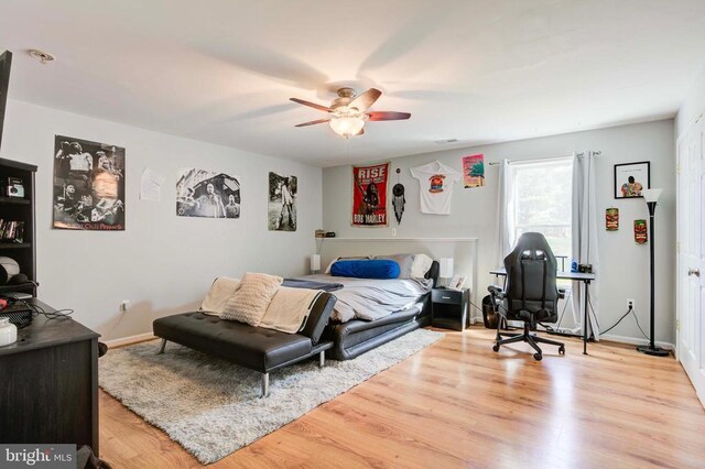 bedroom with light hardwood / wood-style floors and ceiling fan