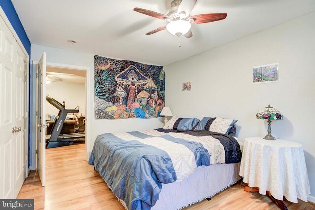 bedroom featuring hardwood / wood-style floors, a closet, and ceiling fan