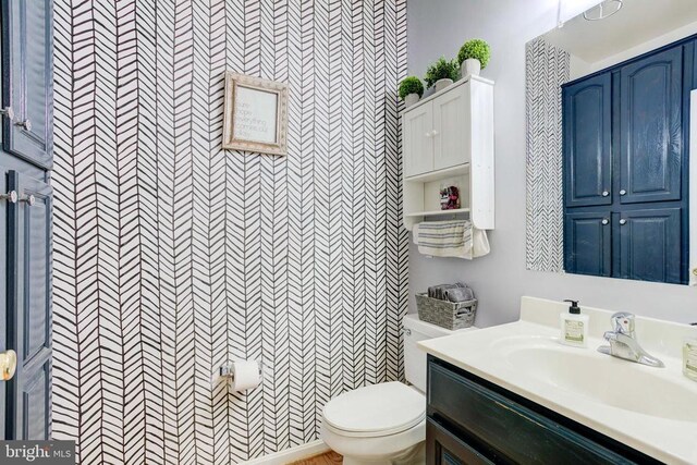 bathroom featuring vanity and toilet