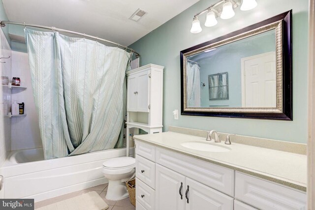 full bathroom with tile patterned flooring, vanity, toilet, and shower / bath combo with shower curtain