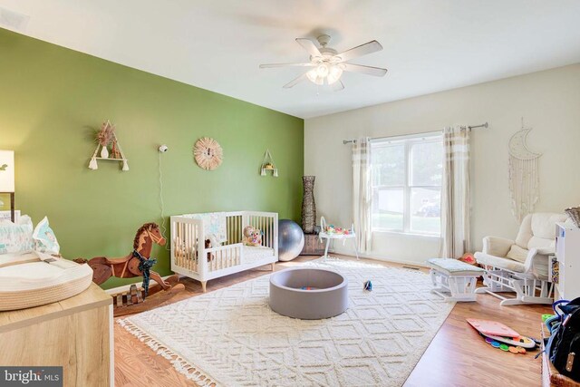 playroom with hardwood / wood-style flooring and ceiling fan